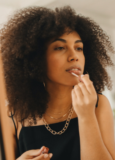 A girl applying lip gloss